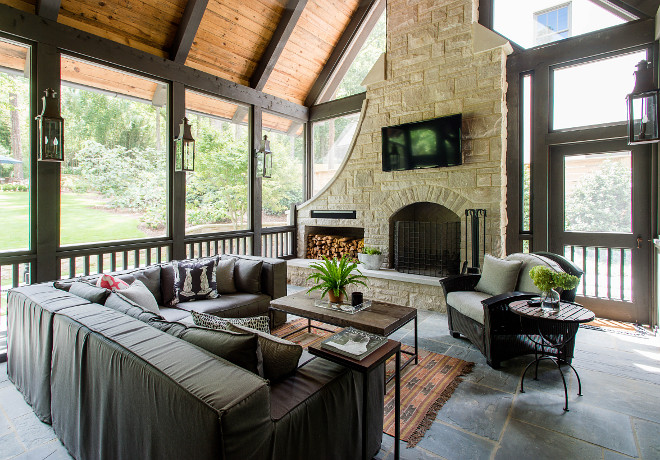 This screened-in porch features a slipcovered outdoor sectional and a gorgeous stone fireplace #screenedporch #screenedinporch #porch #porchfireplace #fireplace #outdoorsectional #outdoorfurniture #outdoorfireplace