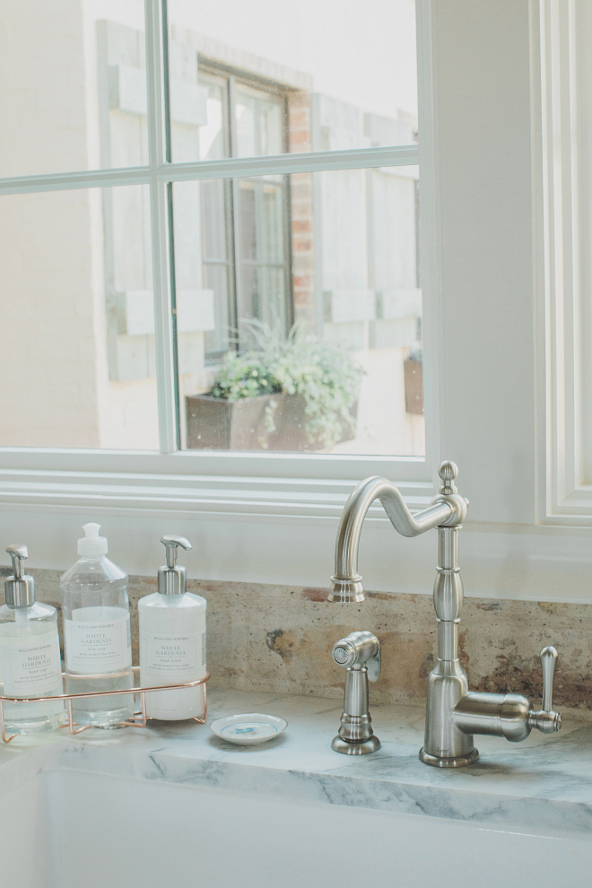 Satin Nickel Kitchen Faucet with marble countertop and brick backsplash