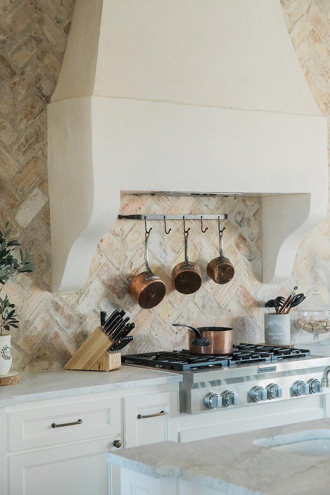 French Kitchen Most beautiful French kitchen with custom stucco hood in a soft creamy white and reclaimed brick backsplash set in a herringbone pattern