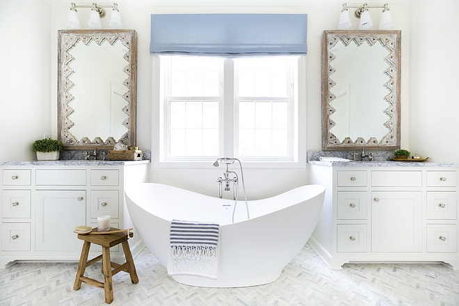 Bathroom with freestanding bathtub flanked by his and hers vanities - sources on Home Bunch