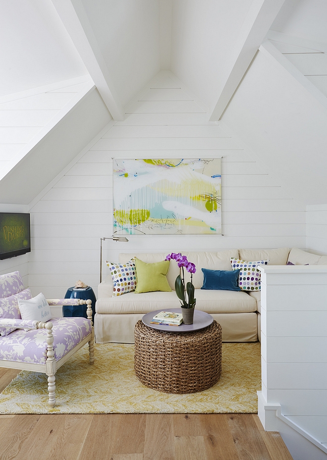 Kids loft reading area with shiplap and colorful decor.