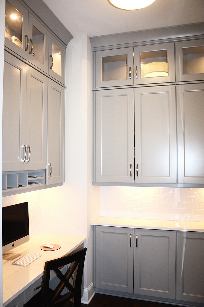 Grey cabinet with white backsplash tile and white quartz countertop