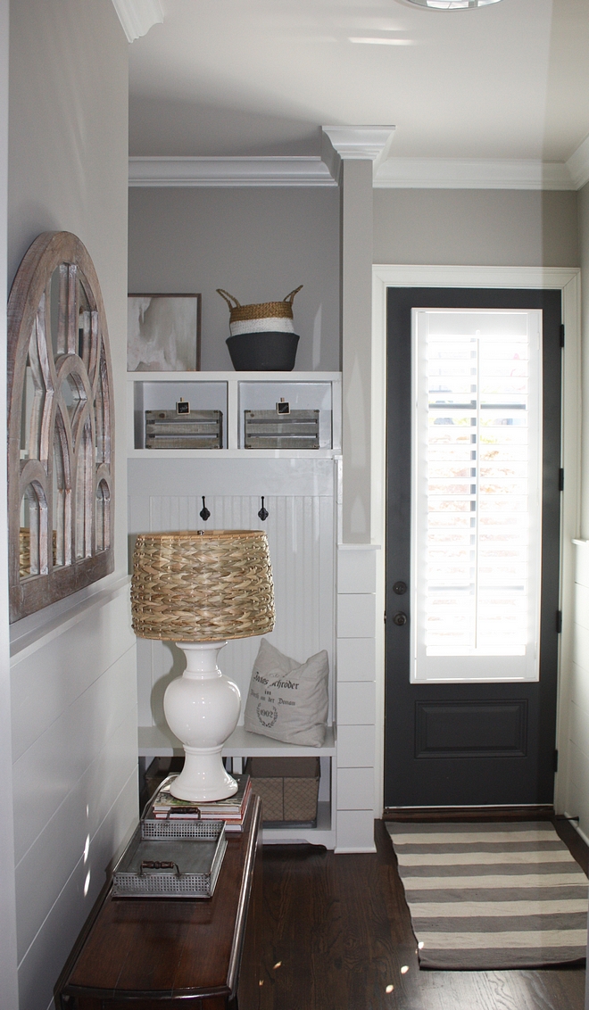 Small mudroom with grey interior door painted in Benjamin Moore Wrought Iron