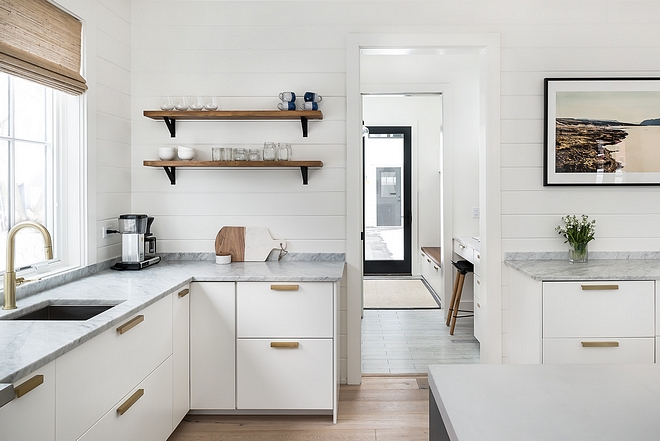 Modern farmhouse kitchen with Carrara marble countertop open shelves shiplap and Satin brass faucet