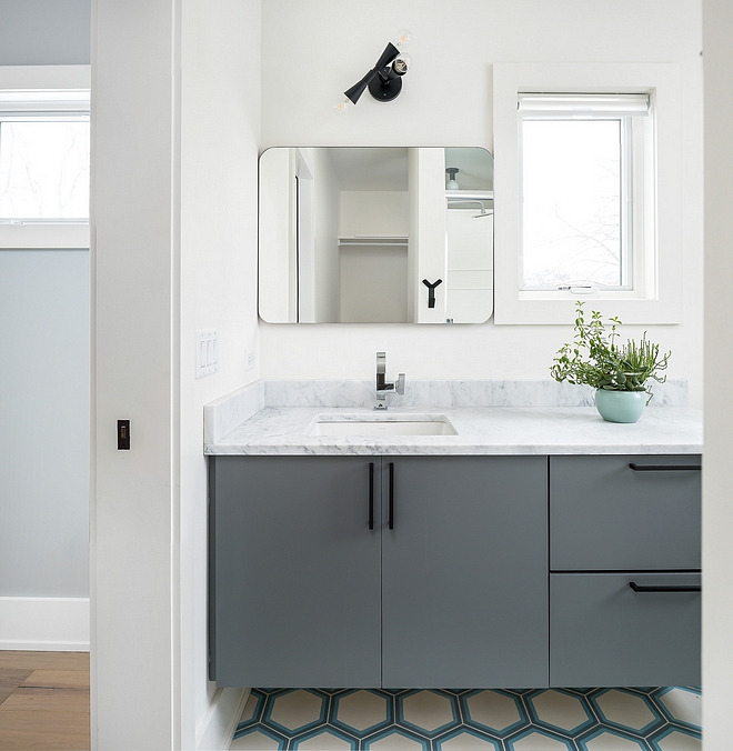 Bathroom Modern vanity painted in a grey paint color with Hex Bathroom floor Tile